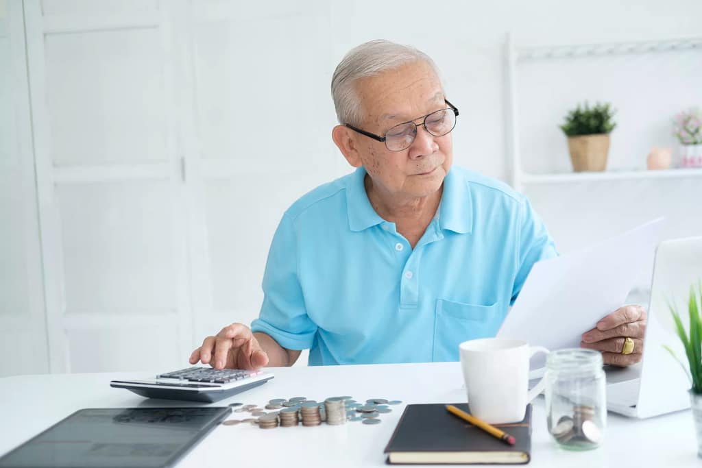 senior man document laptop calculator gettyimages .jpg