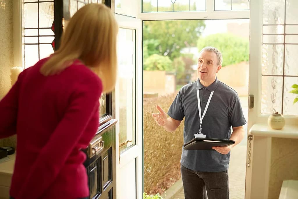 Homeowner opens the door for man with clipboa.width gBDUEkT.jpg