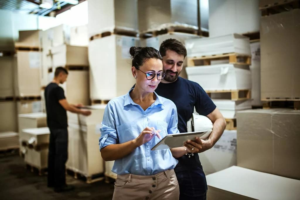 Workers in warehouse surrounded by boxes. YAT.width .jpg