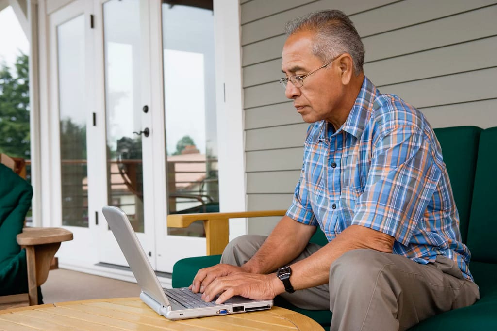 older man laptop outdoors gettyimages .jpg