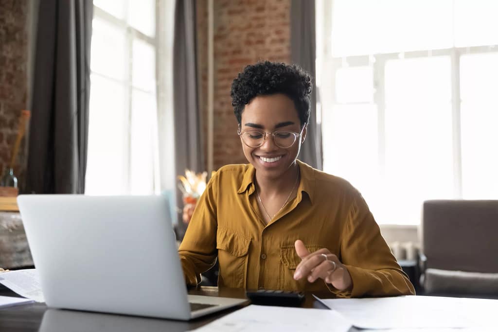 investor smiling computer getty images download from fool brandfolder.jpg