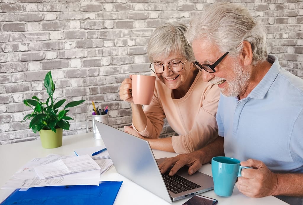 senior couple laptop smiling gettyimages