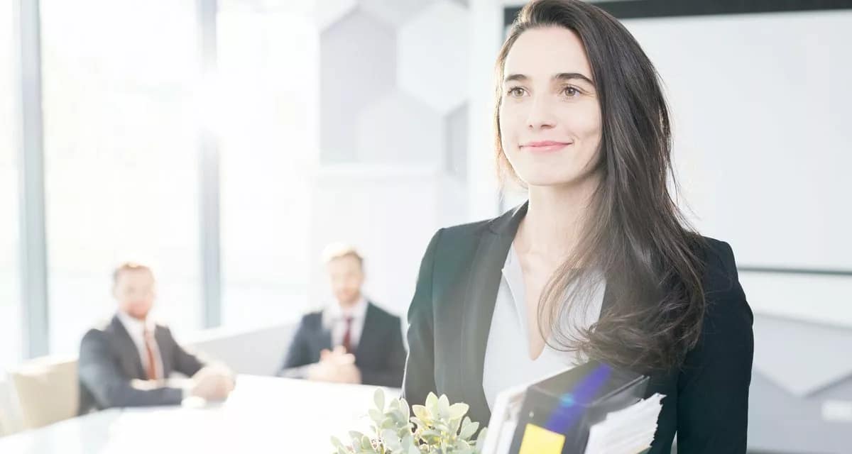 Happy businesswoman leaving job with box of b.width qZUZkS.jpg