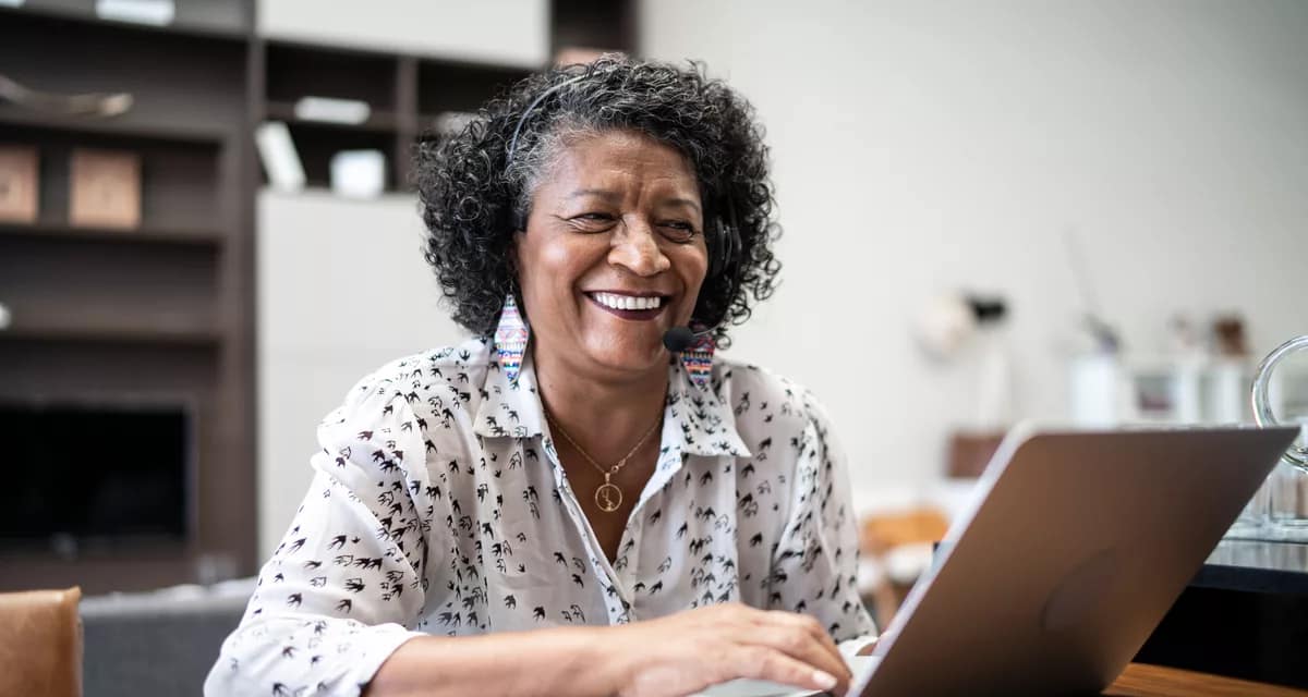 smiling person sitting in front of laptop.jpg