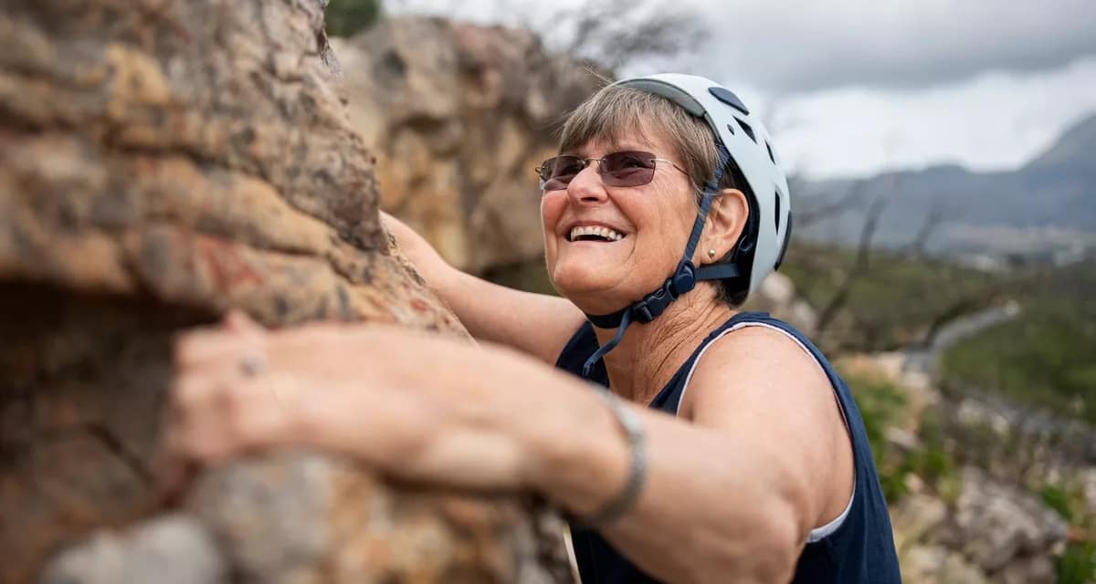 smiling person rock climbing.jpg