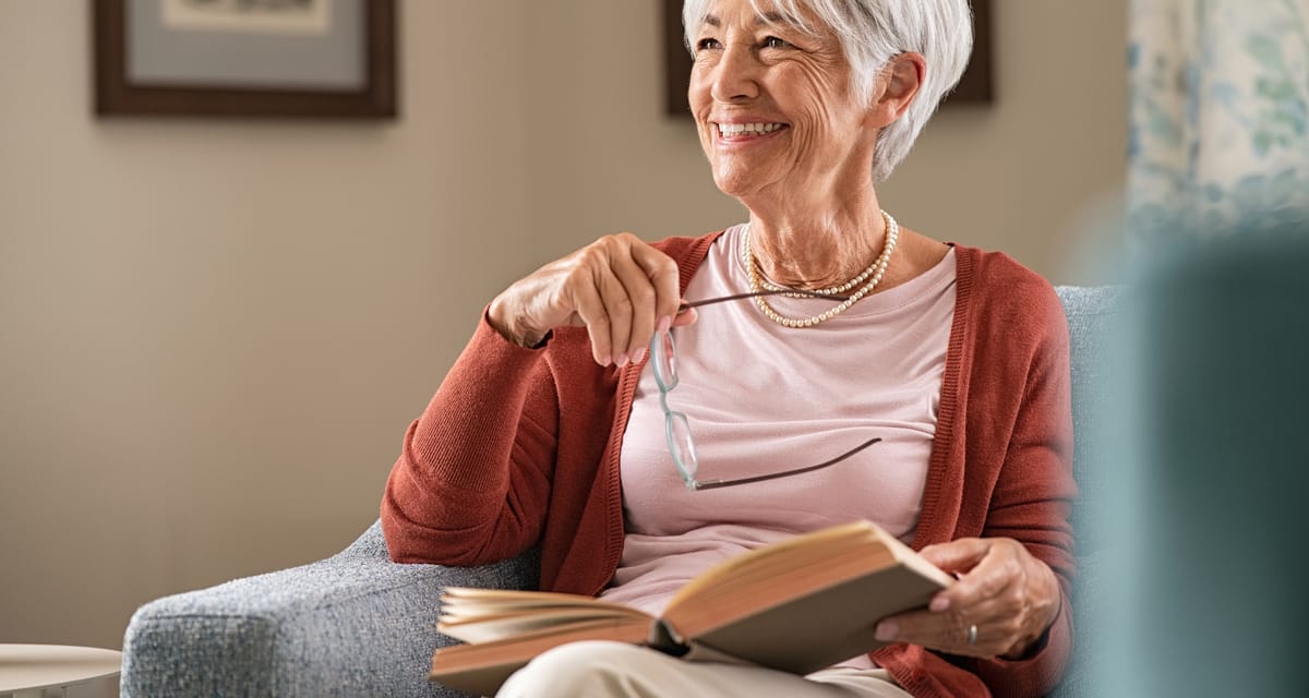 smiling person reading a book.jpg
