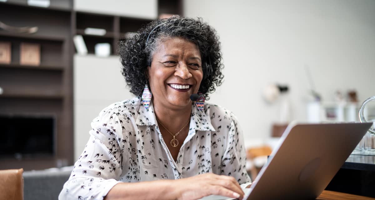 smiling person sitting in front of laptop.jpg