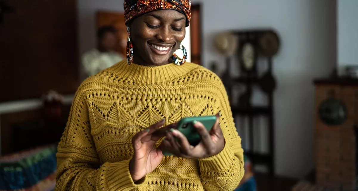smiling person looking at smartphone.jpg