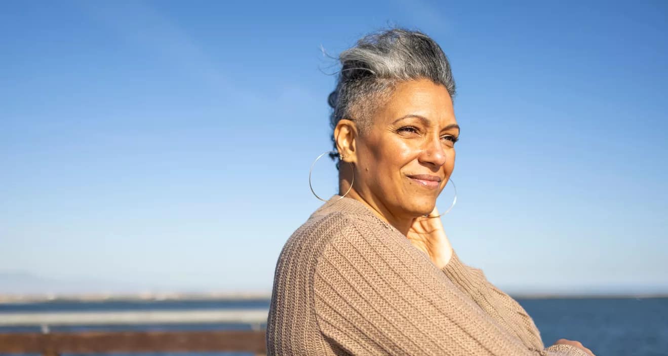 smiling person looking out over the ocean.jpg