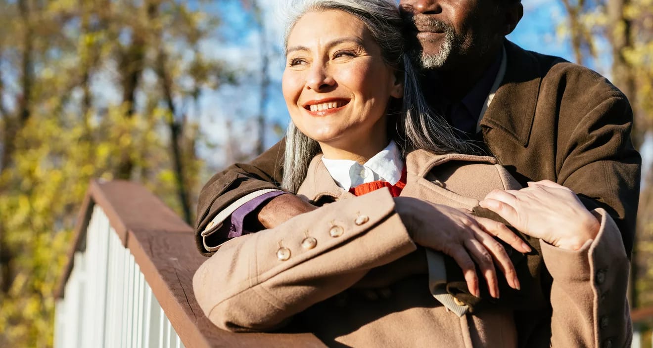 retired interracial couple hugging in love x aae.jpg
