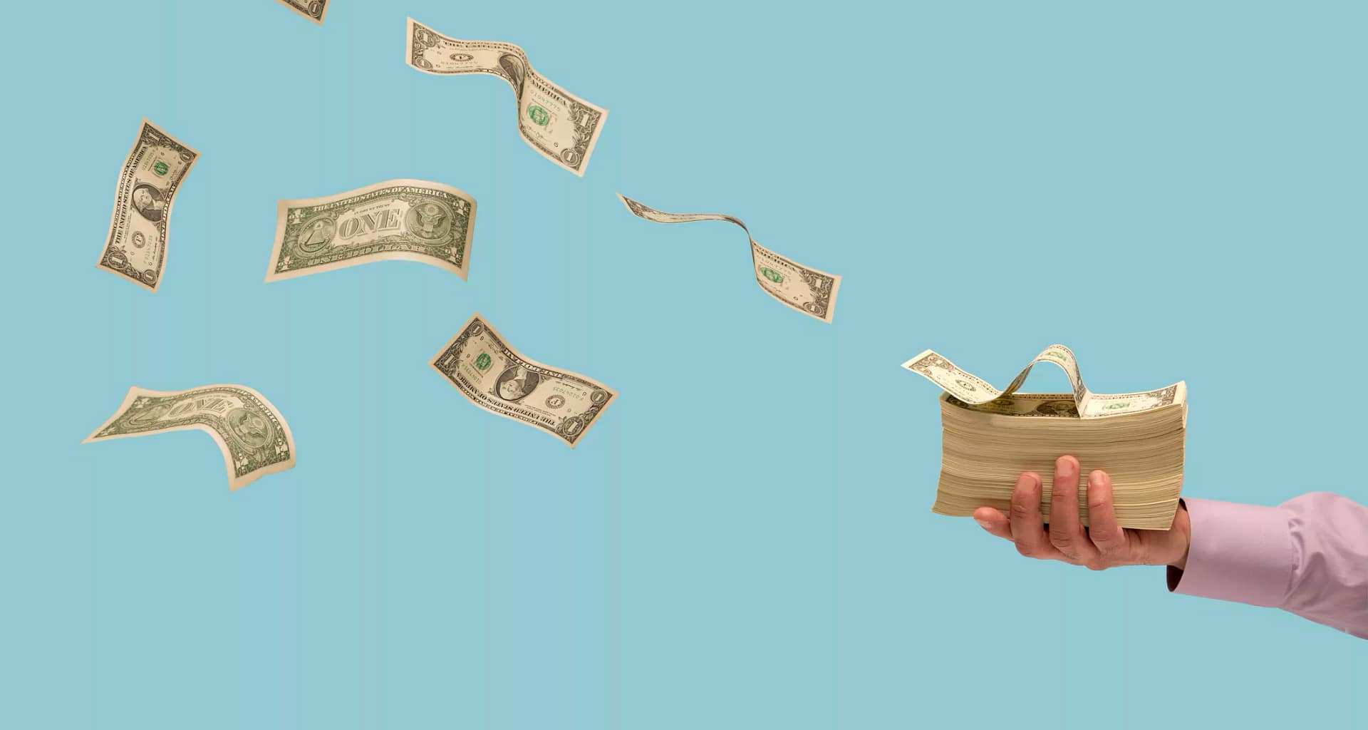 dollar bills flying off a stack of money.jpg