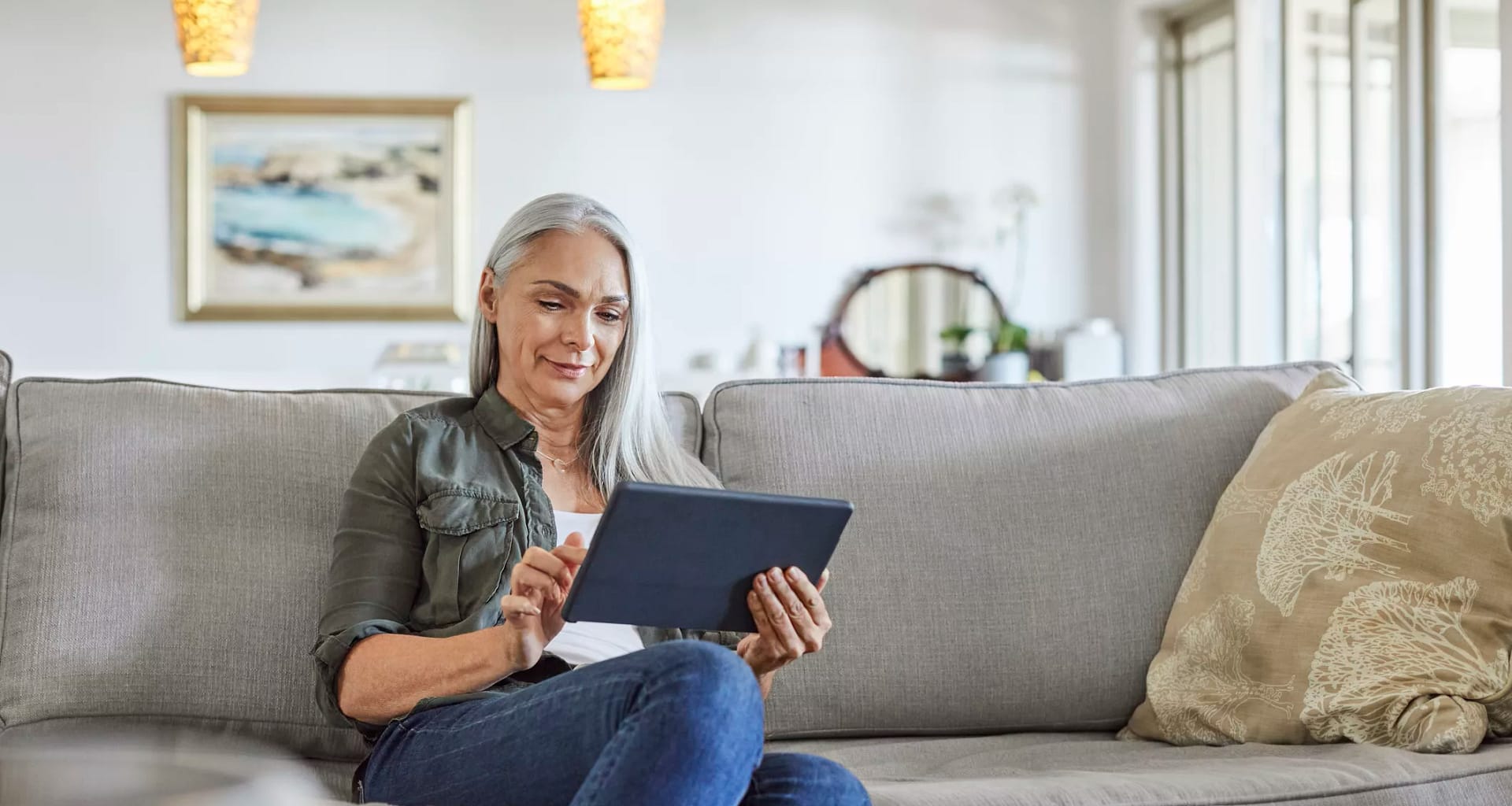 older woman couch tablet gettyimages .jpg