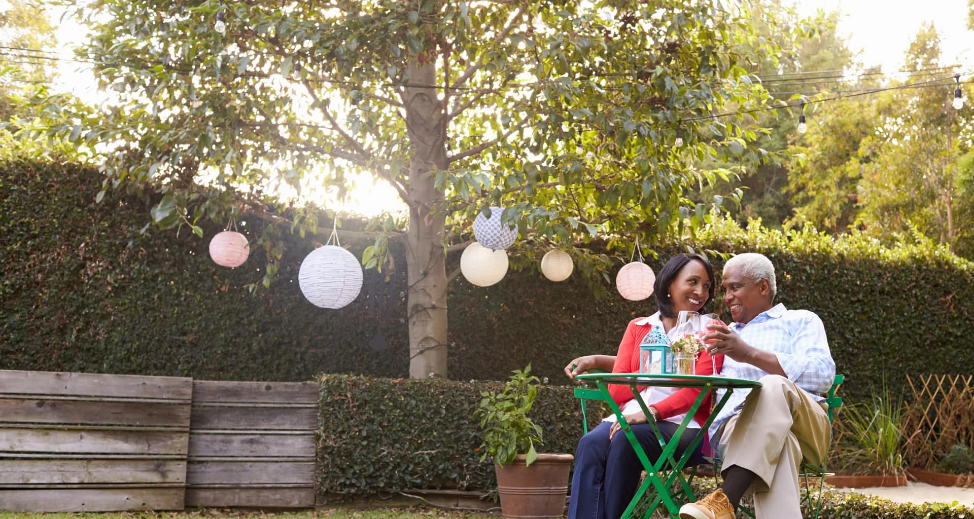 mature couple relaxing drinking wine together in their backyard.jpg
