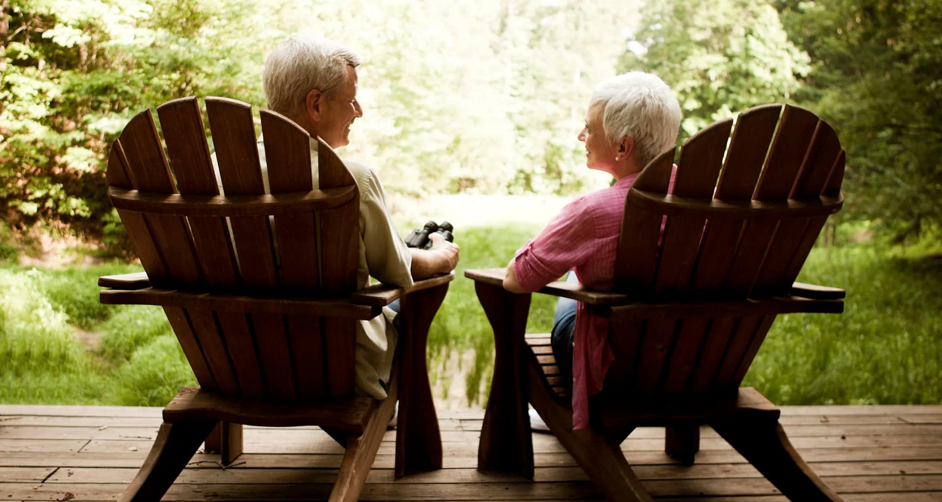 senior couple sitting in chairs on porch.jpg