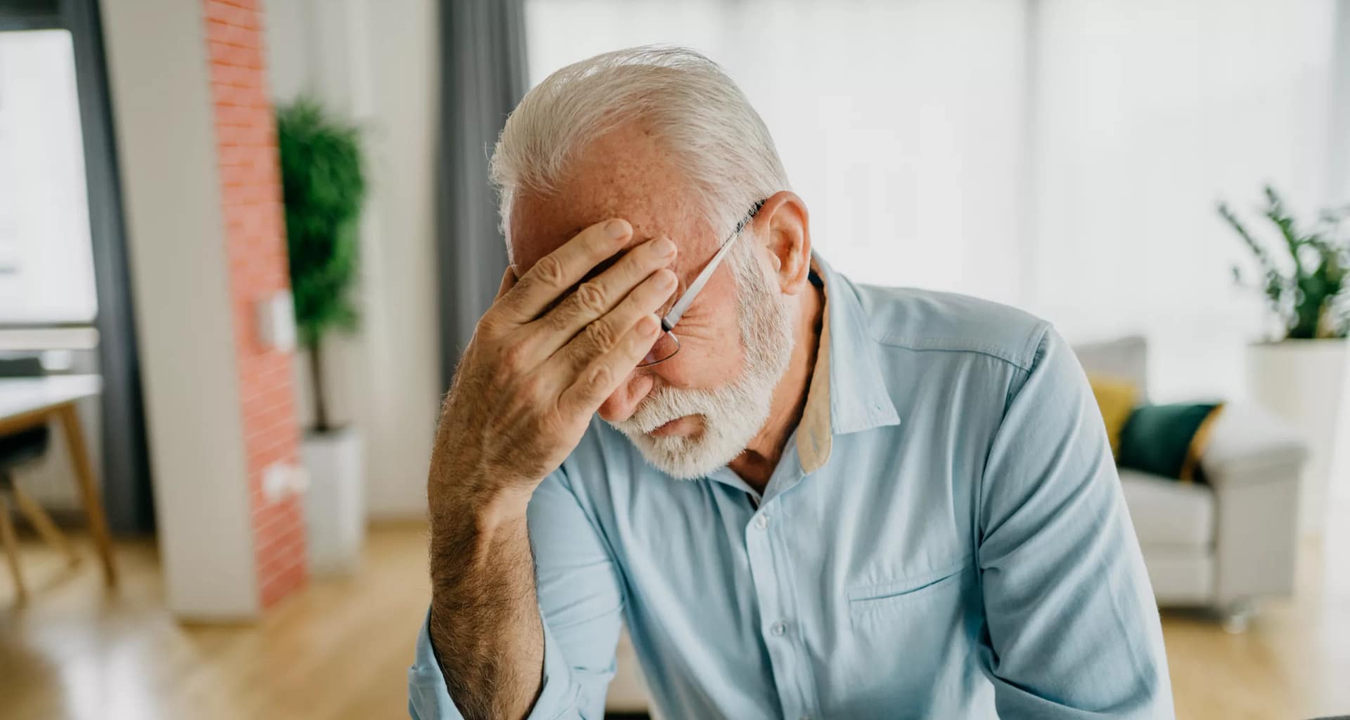 senior man holding face gettyimages .jpg