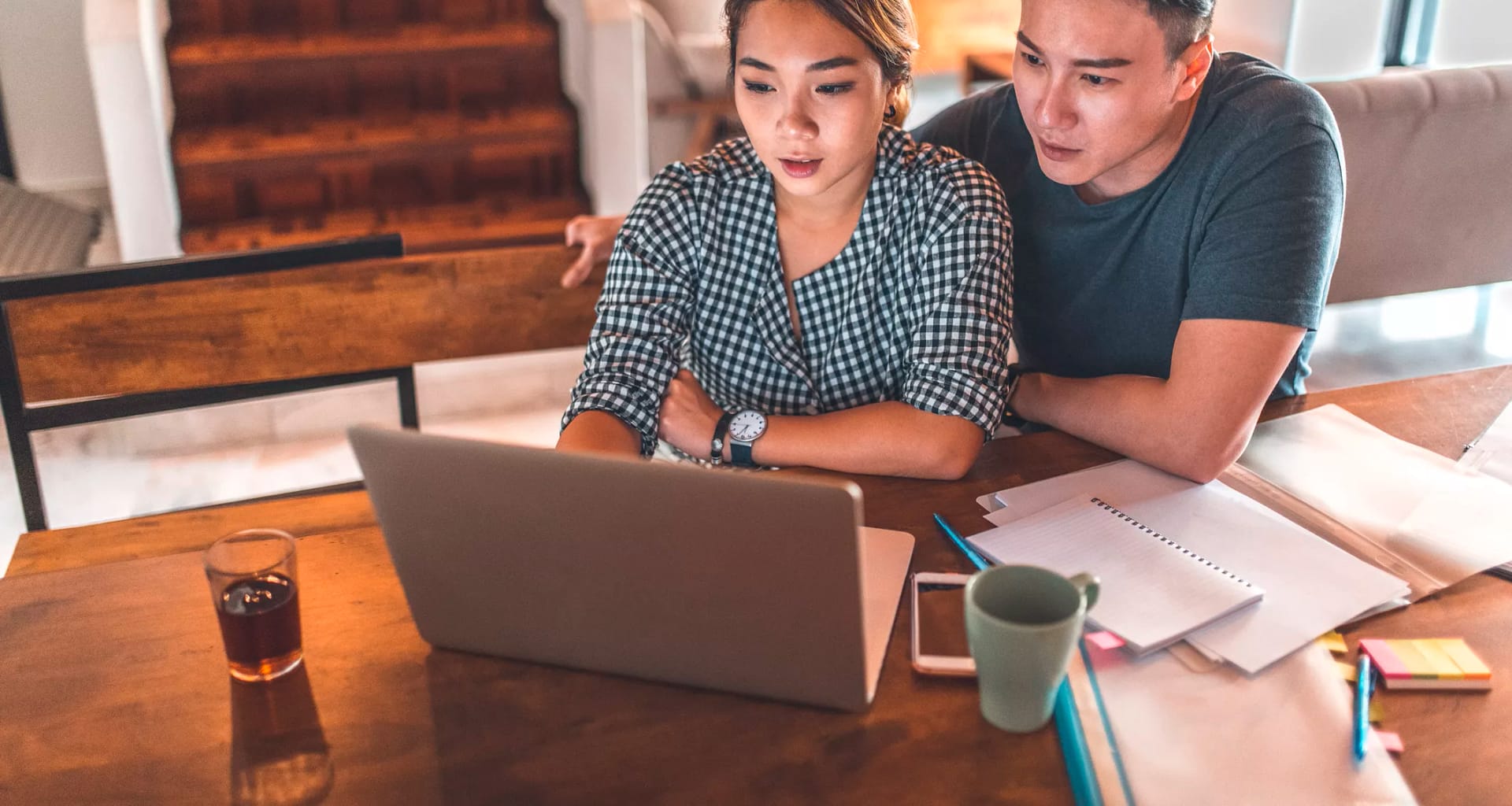 serious couple looking at laptop and discussing finances.jpg