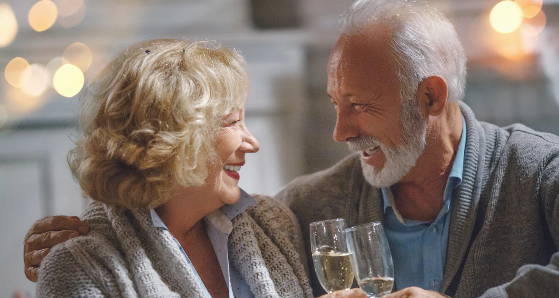 smiling seniors clinking champagne glasses together.jpg