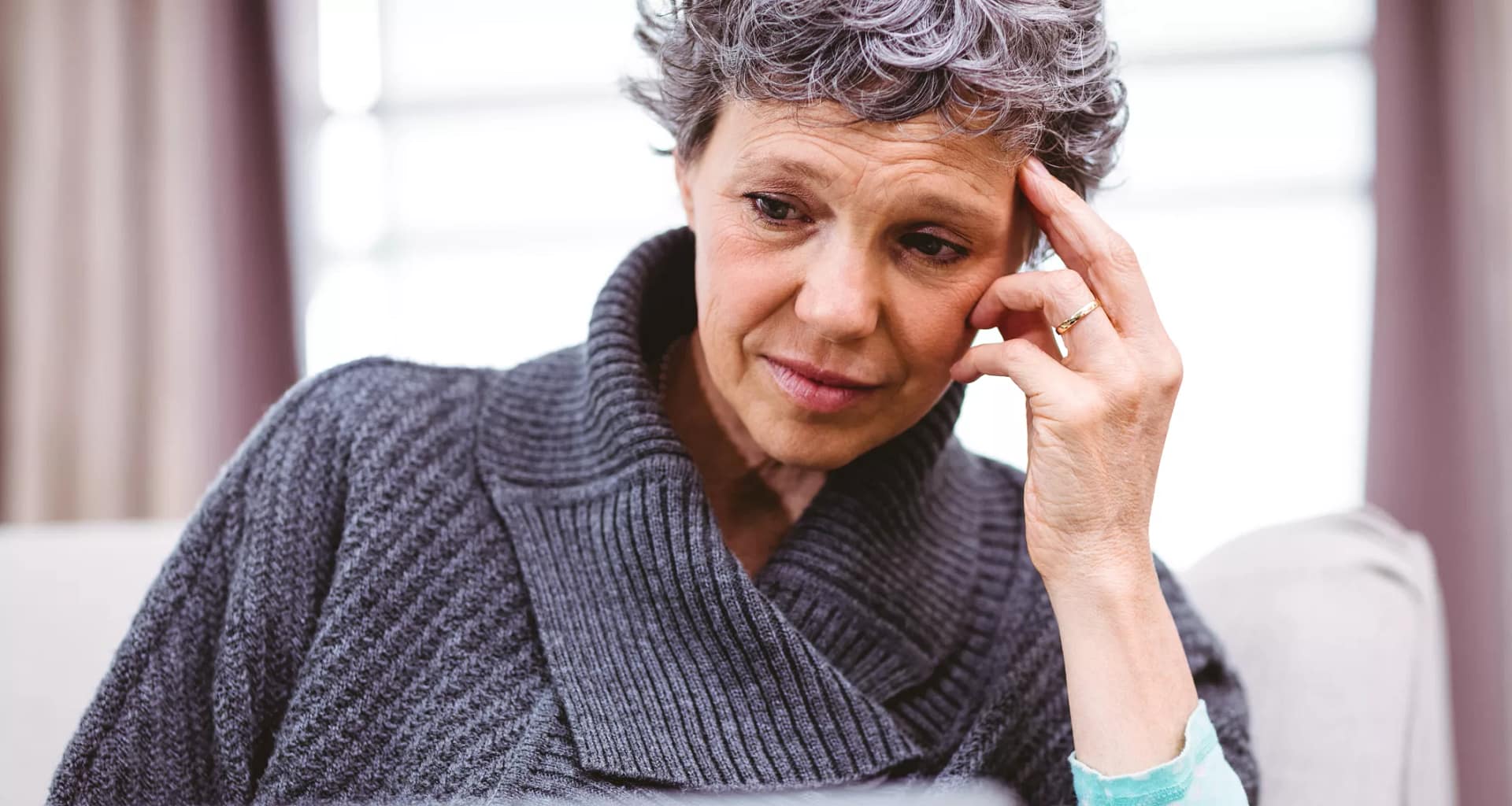 mature woman looking at laptop computer with raised eyebrows and thinking confused doubtful uncertain unsure skeptical.jpg