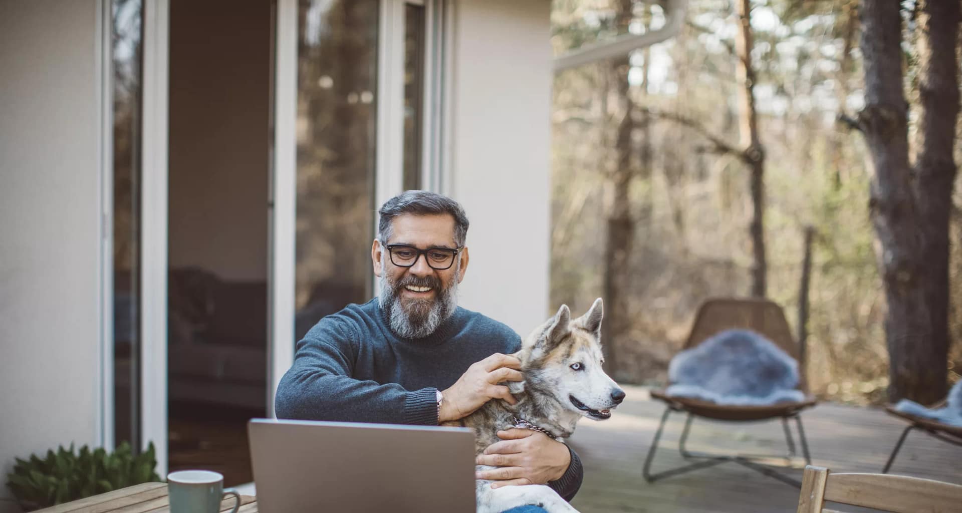 older man at laptop with dog gettyimages .jpg