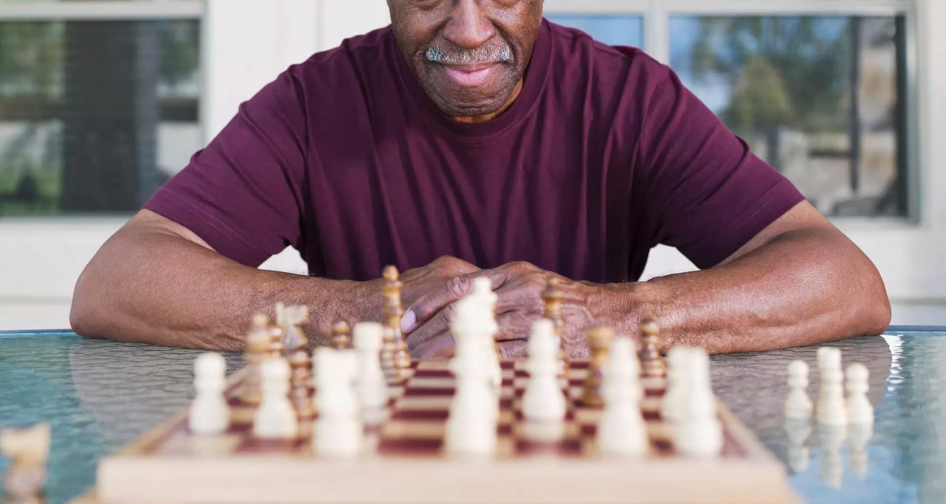 older man playing chess strategy moves winning.jpg