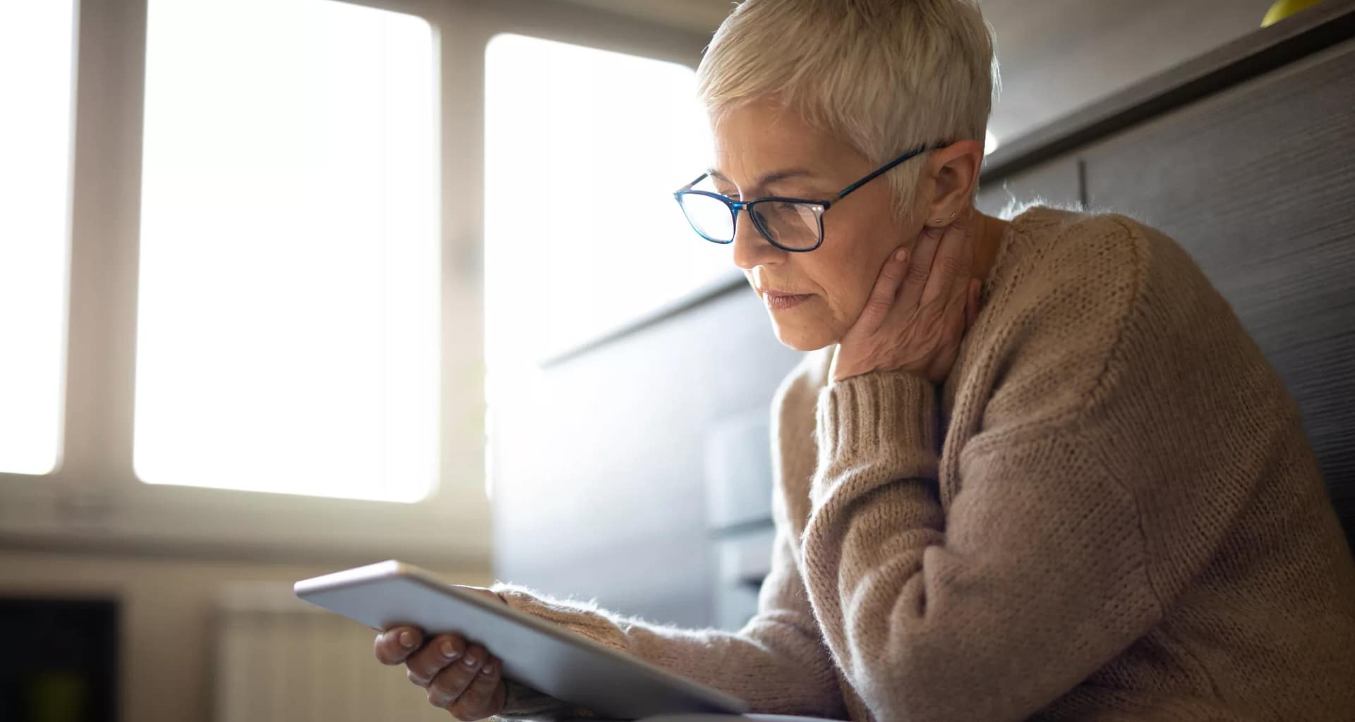 senior woman holding tablet gettyimages .jpg