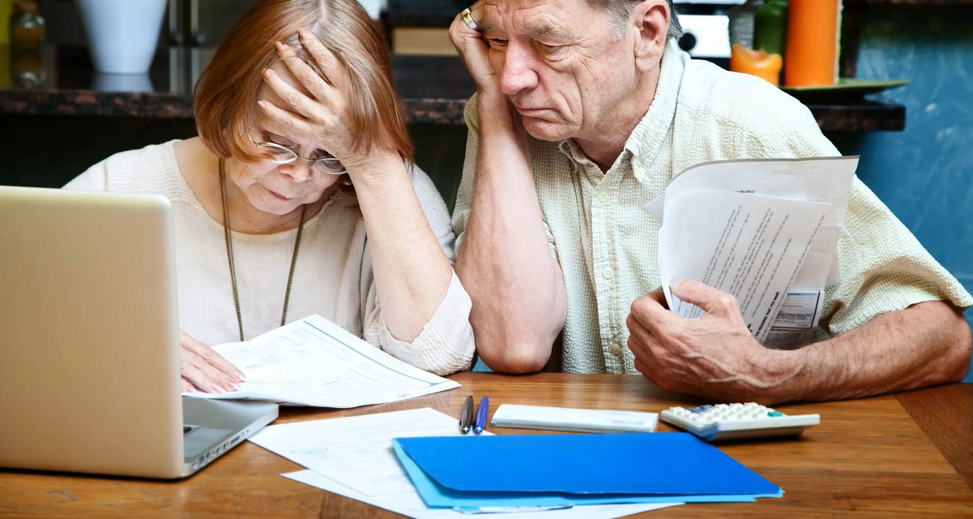 senior couple worried looking at bills finances debt.jpg