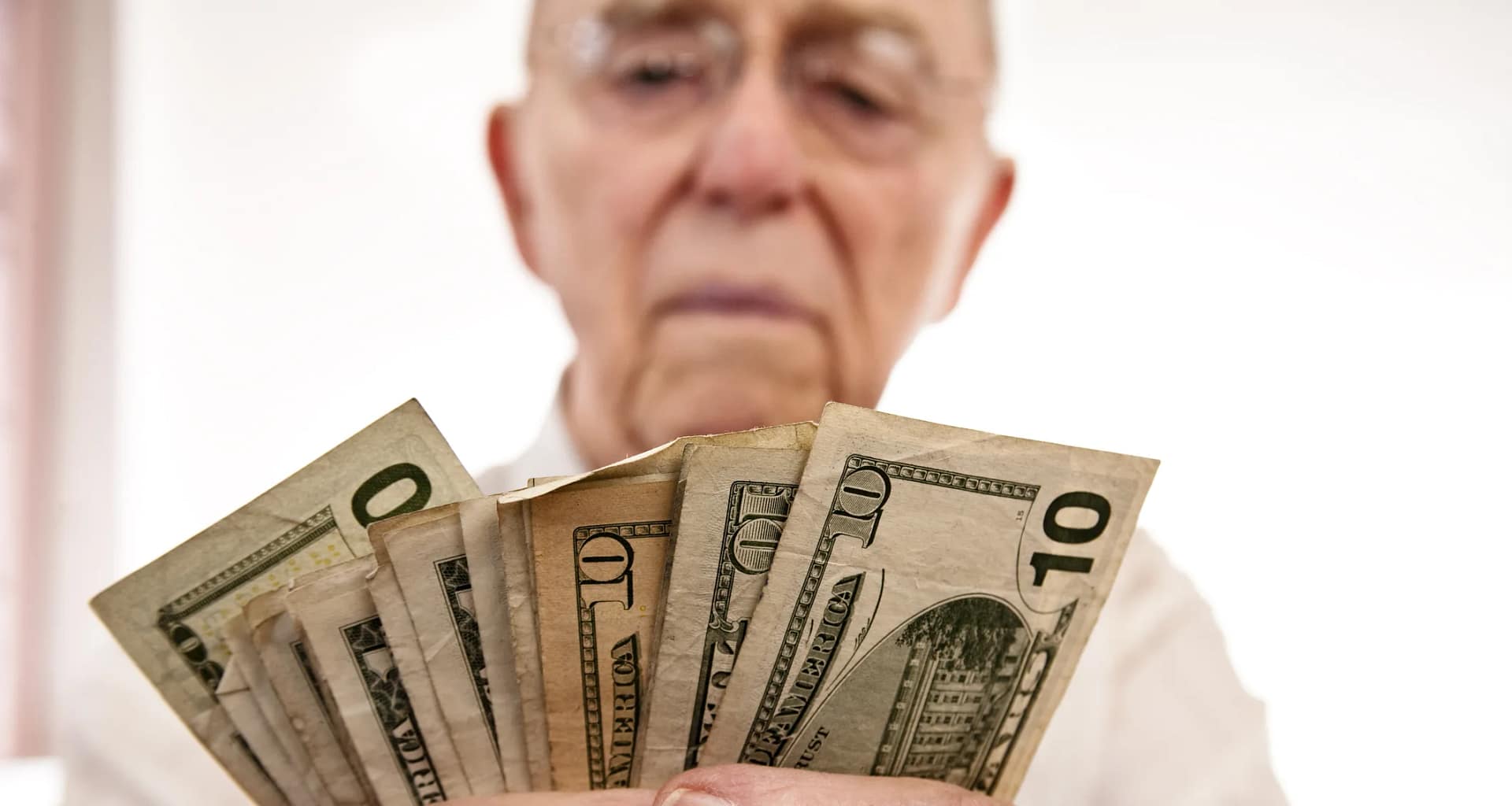 senior holding assortment cash bills social security retire getty.jpg