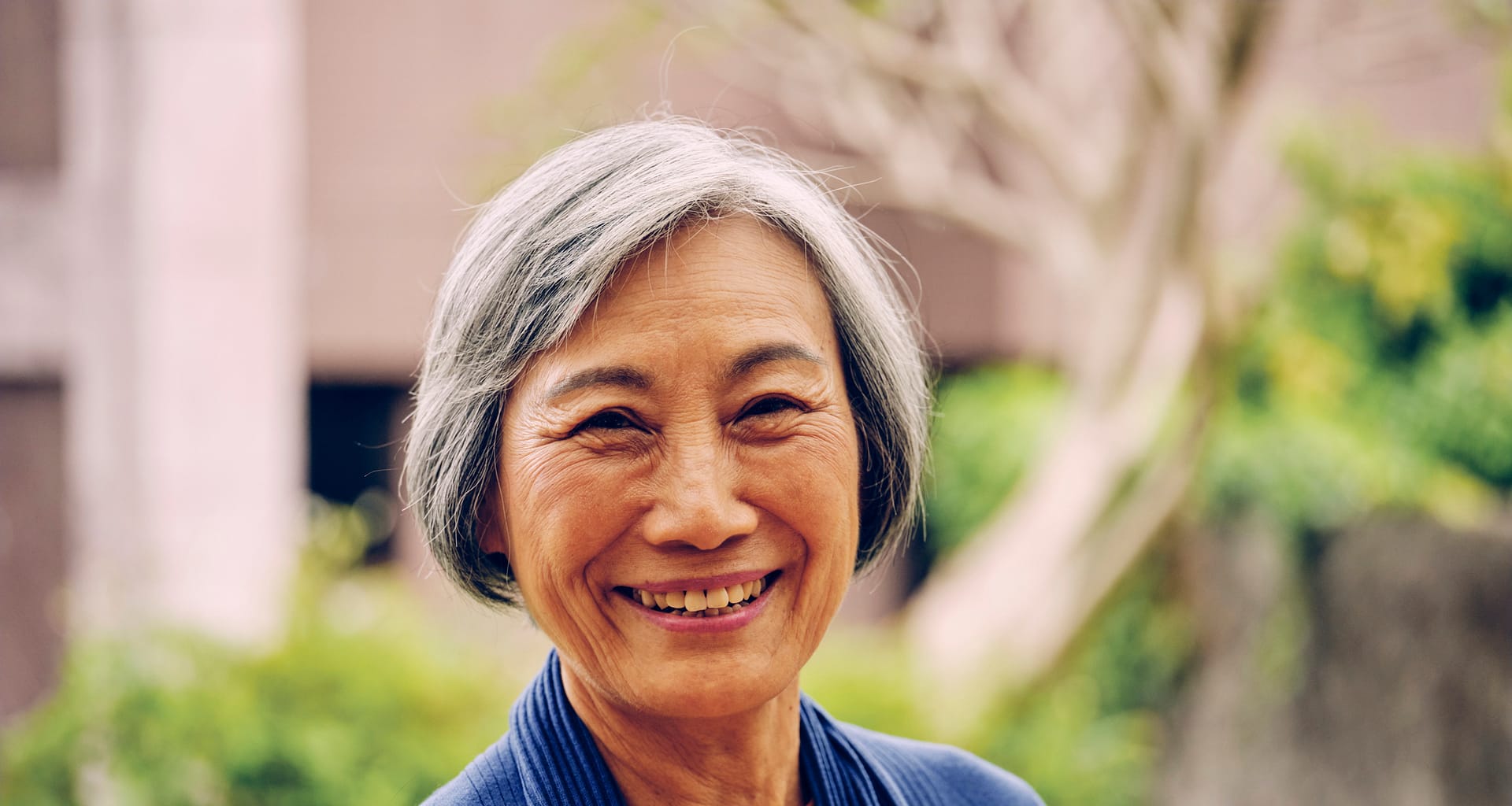 getty smiling happy outdoors blue sweater.jpg