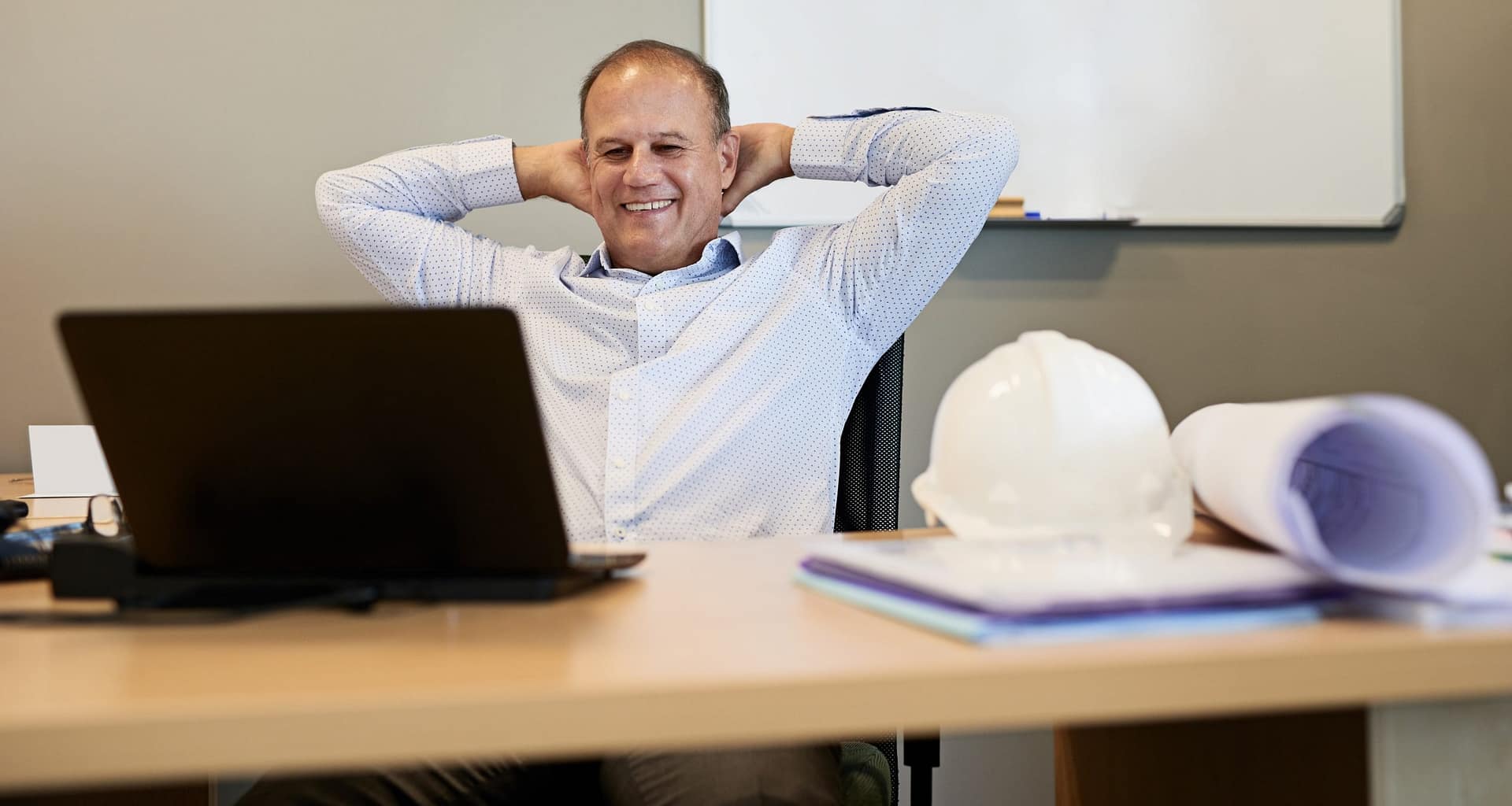 man s desk smiling gettyimages .jpg
