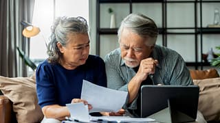 serious couple looking at documents together