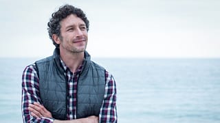 a person standing in front of a body of water gettyimages