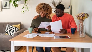 couple reviewing papers budgeting