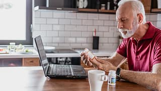 older man pills laptop gettyimages