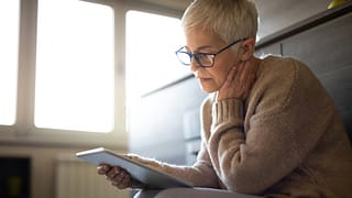 senior woman holding tablet gettyimages