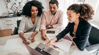 Couple discuss finances with lender PIDvJe.width