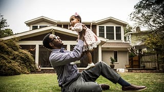 Father and toddler daughter play in homes bac.width leyKMuB