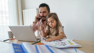 Father using laptop while on cell phone with .width rmjZiis