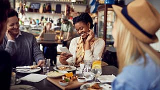 Group of friends enjoying food at a restauran.width vWjh