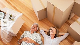 Happy mature couple laying on the floor surro.width rNWebku.jpg