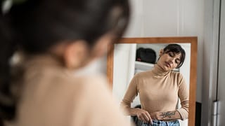 Person trying on clothing in mirror. EambWvL.width