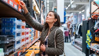 Shopper inspecting items in home improvement .width