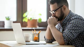 Stressed man with laptop pboAzQu.width