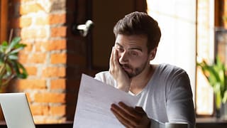 Upset man reading bills dHotgB.width .jpg