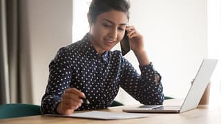 Woman with laptop on phone.width .jpg