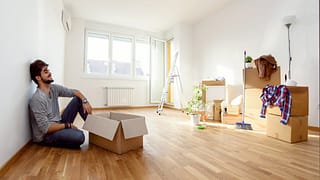 Young man empty apartment boxes imMTFem.width