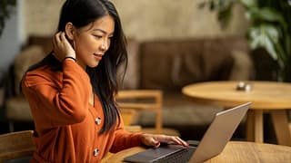 Young woman using her laptop lHMivv.width