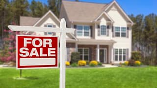 a house with a for sale sign in front gettyimages