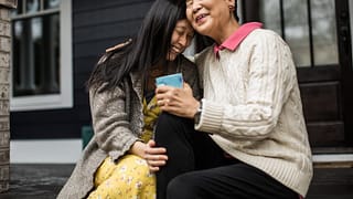 adult woman and senior mom seated hugging Syn.width .jpg
