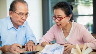 concerned senior asian couple