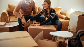 couple packing moving boxes.width